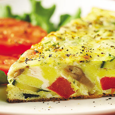 Frittata on a plate with veggies