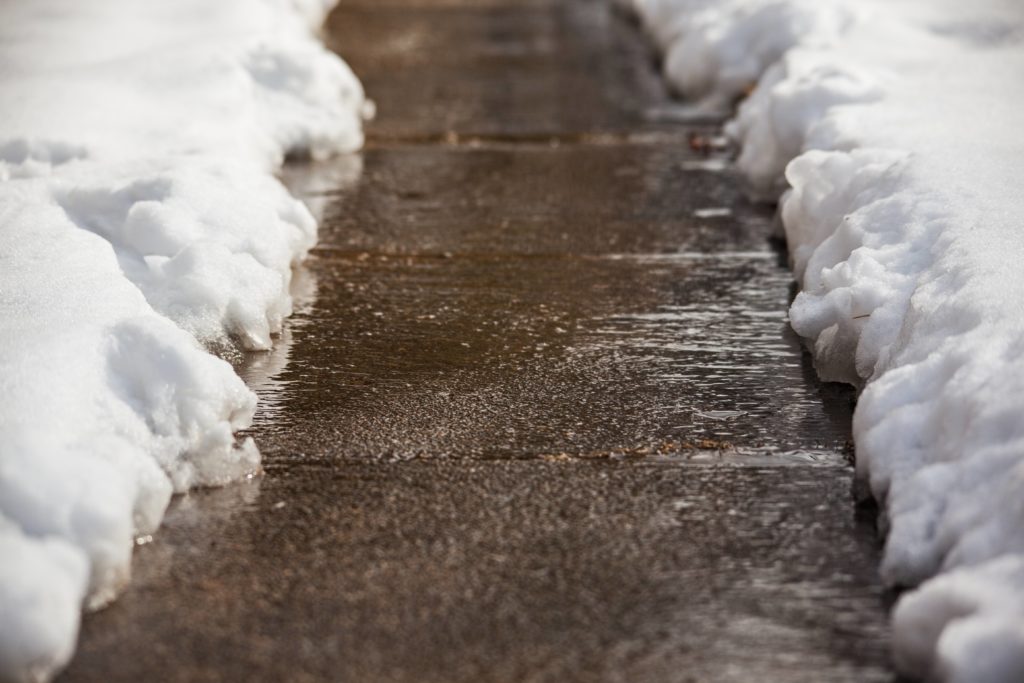 Ice melting on the sidewalk