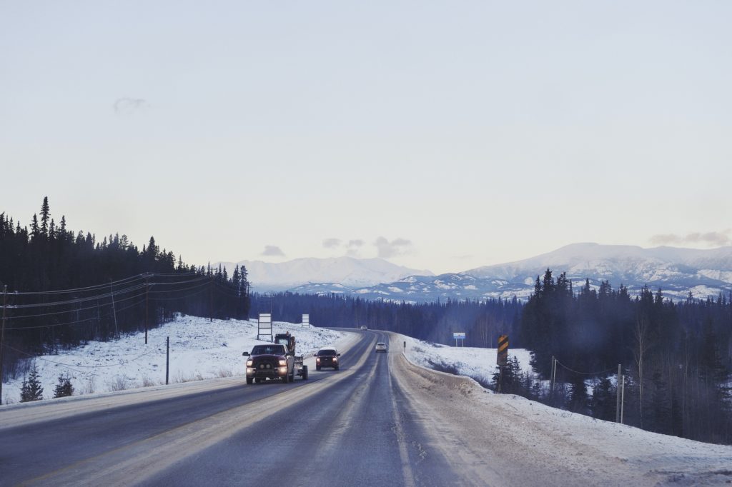 Snowy road through a windshield