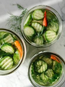 Three open jars of quick dill pickles