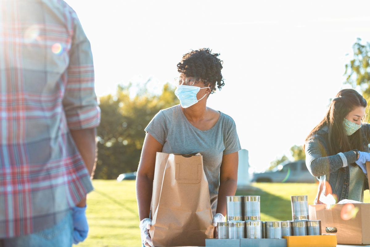 A woman wearing a mask selling items